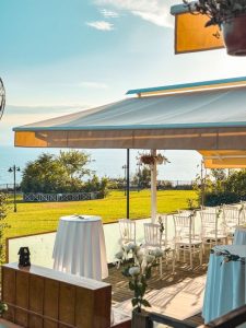 Charming wedding setup with white decor on a terrace overlooking the sea in Antalya, Türkiye.