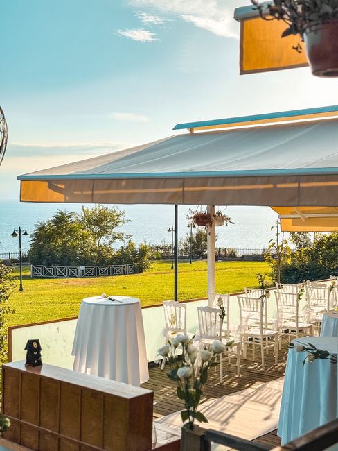 Charming wedding setup with white decor on a terrace overlooking the sea in Antalya, Türkiye.